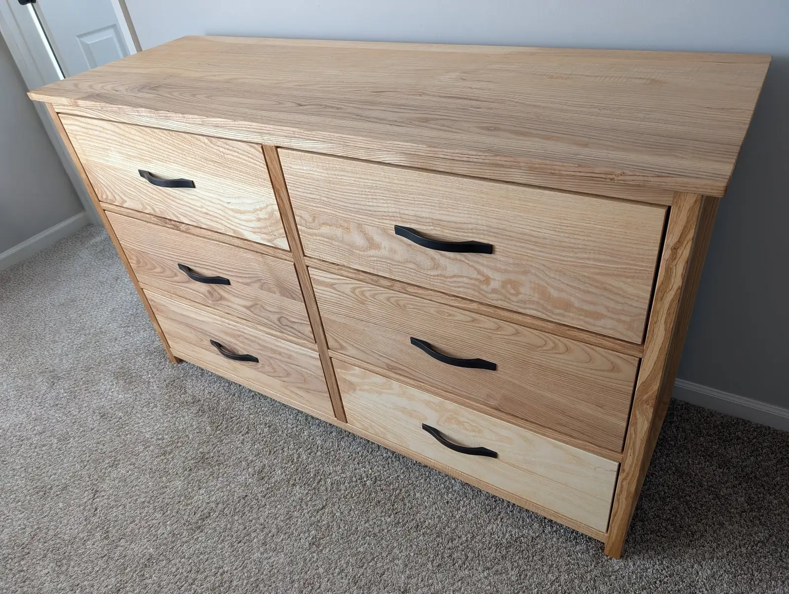 Finished six-drawer dresser in solid ash with blackened bronze pulls